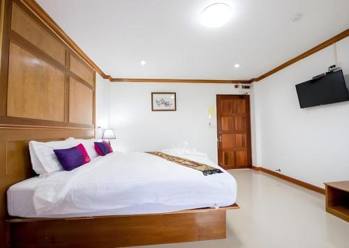 a bedroom with a bed and a flat screen tv at Thatphanom View Hotel Nakhon in Nakhon Phanom