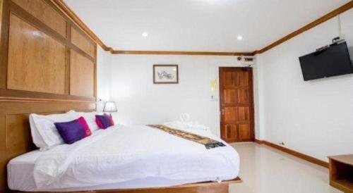 a bedroom with a bed and a flat screen tv at Thatphanom View Hotel Nakhon in Nakhon Phanom