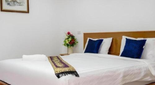 a bedroom with two beds with blue and white pillows at Thatphanom View Hotel Nakhon in Nakhon Phanom
