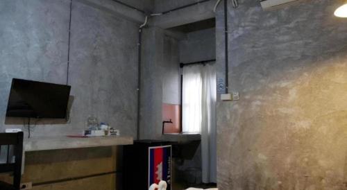 a kitchen with a counter and a window in a room at 41Studio in Nakhon Phanom