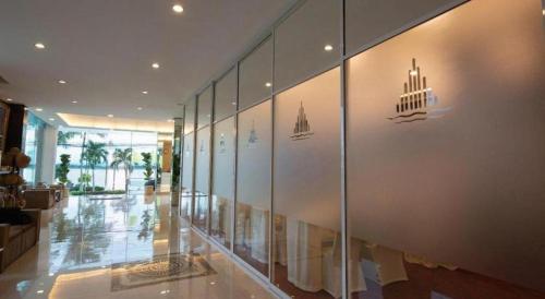 a hallway of a building with a wall of glass at Phuglong Hotel in Phayao