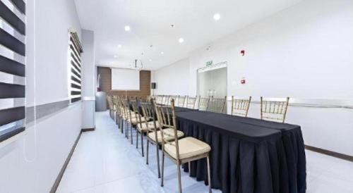a conference room with a long table and chairs at Eighty Eight Hotel in Koronadal