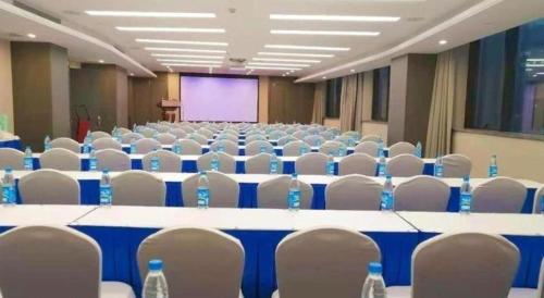 a conference room with tables and chairs and water bottles at Rosedale Hotel Taicang in Taicang