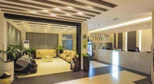 a lobby with yellow furniture in a building at Eighty Eight Hotel in Koronadal