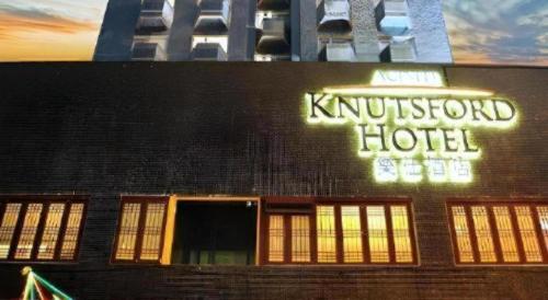 a hotel sign on the side of a building at Acesite Knutsford Hotel in Hong Kong