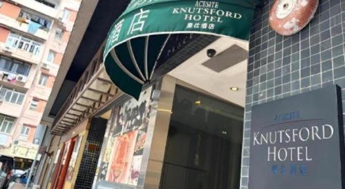 a kitschord hotel sign on the side of a building at Acesite Knutsford Hotel in Hong Kong