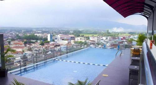 a large swimming pool on top of a building at Java Lotus Hotel Jember in Jember