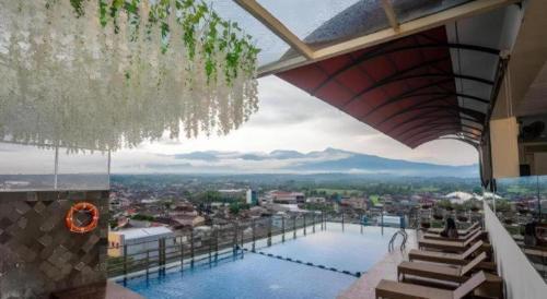 a view of a swimming pool on top of a building at Java Lotus Hotel Jember in Jember