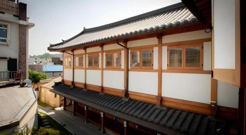 a building with wooden windows and a roof at Nabijam Hanok Hotel in Jeonju