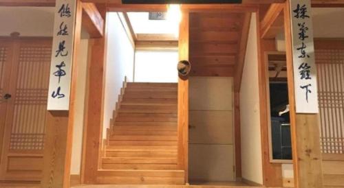 a room with stairs with asian writing on the walls at Nabijam Hanok Hotel in Jeonju