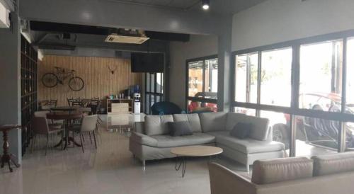 a living room with a couch and chairs and a table at Sattahip 9 Boutique Hotel in Pattaya Central