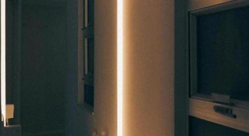 a light on the side of a wall in a room at SLEEEP HKG Causeway Bay in Hong Kong