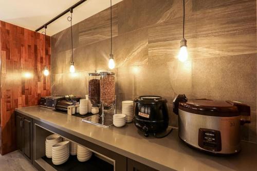a kitchen with a counter top with a coffee maker and a toaster at Cheongju Maryjane Hotel in Cheongju