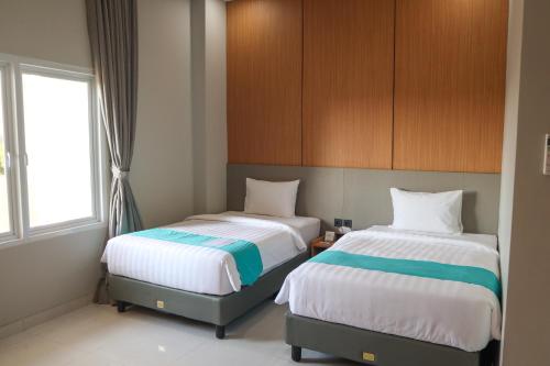 Commodious Hotel Kupangにあるベッド
