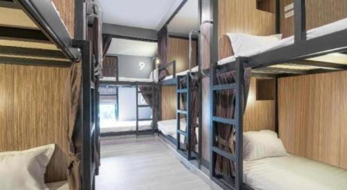 a room with three bunk beds in a building at OYO 726 Sookjai Cafe and Hostel in Chiang Mai