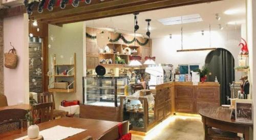 a store with a table and chairs in a room at Need a Nap Hostel Phrae in Phrae