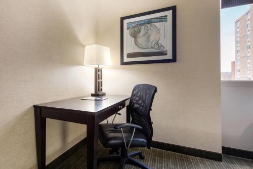 a desk with a lamp and a chair in a hotel room at Quality Inn & Suites Charleston - Civic Center in Charleston