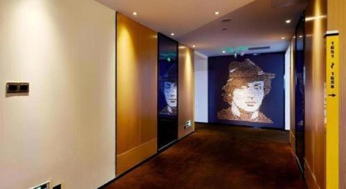 a hallway with a large painting of a statue at 7 Days Premium Nanjing Gaochun Beiling Road Branch in Gaochun