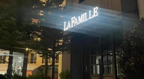 a street sign that reads akasha millie in front of a building at La Famille in Yangyang