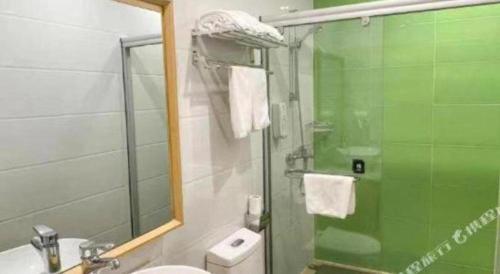 a bathroom with a shower and a toilet and a sink at GreenTree Inn Shanghai National Convention and Exhibition Center Huaxiang Road in Shanghai