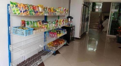a store with shelves filled with different types of snacks at OYO 75399 Choktipparat Place in Udon Thani