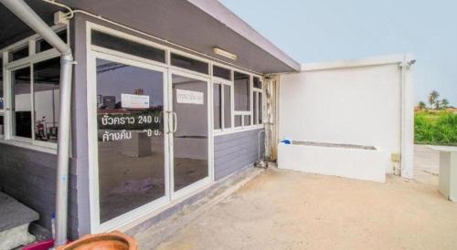a garage with sliding glass doors on a building at OYO 622 Sixsense Hotel in Si Racha