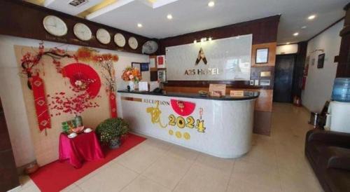 a restaurant with a counter in a room at New Moon Hotel in Hanoi