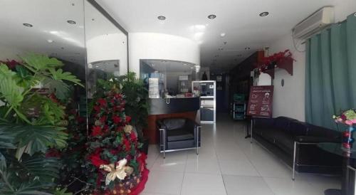 a restaurant with christmas trees and plants in a room at Marcian Business Hotel in Zamboanga