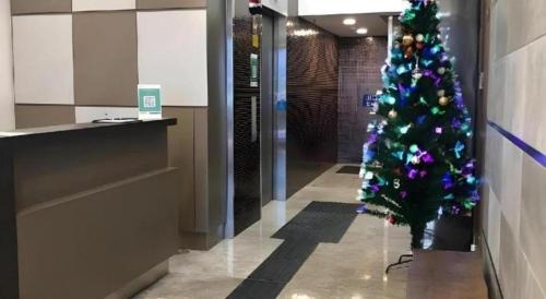 a christmas tree in the hallway of a building at WE Hotel Kowloon in Hong Kong