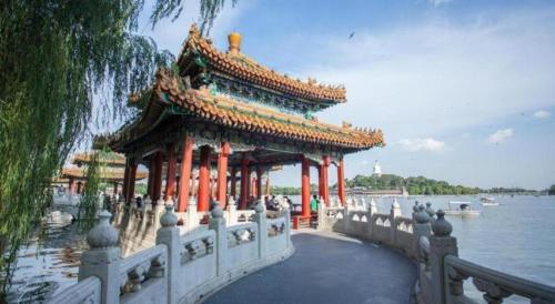 a pavilion on a bridge over a body of water at Capital Hotel in Beijing