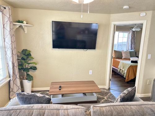 a living room with a couch and a tv on the wall at Near Downtown- Kitchen-washerdryer-parking in Medford