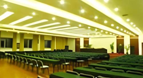 a large room with chairs and tables and lights at New Friendship Hotel in Luoyang
