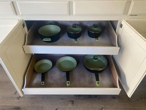 a drawer with green pots and pans in it at Near Downtown- Kitchen-washerdryer-parking in Medford