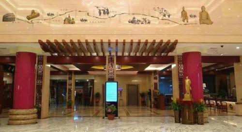 a large building with a lobby with red pillars at New Friendship Hotel in Luoyang