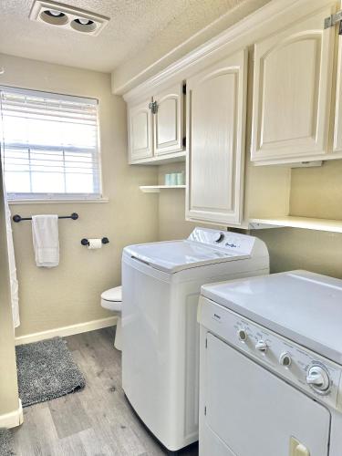 a white bathroom with a washer and dryer in it at Near Downtown- Kitchen-washerdryer-parking in Medford