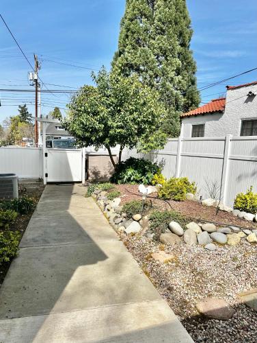 a sidewalk in front of a house with a fence at Near Downtown- Kitchen-washerdryer-parking in Medford