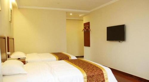 Ένα ή περισσότερα κρεβάτια σε δωμάτιο στο GreenTree Inn Hebei Zhangjiakou Xiahuayuan Xinchen Road Express Hotel
