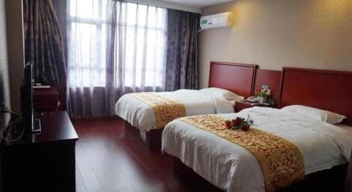 Ένα ή περισσότερα κρεβάτια σε δωμάτιο στο GreenTree Inn Hebei Zhangjiakou Xiahuayuan Xinchen Road Express Hotel
