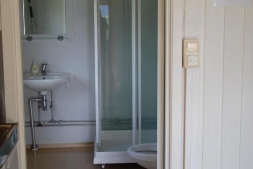 a bathroom with a shower and a toilet and a sink at Volsdalen Camping in Ålesund