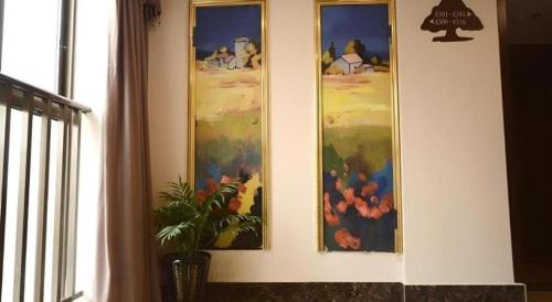 three paintings on a wall in a room at GreenTree Inn Anhui Xuancheng Ningguo NinGYAng East Road Darunfa Branch in Xuanzhou