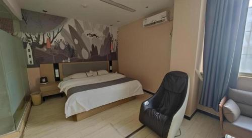 a bedroom with a bed and a chair in it at Thank Inn Hotel He'nan Xinxiang Changyuan Bo'ai Road in Changyuan