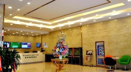 a lobby with a large flower arrangement in a building at GreenTree Inn Haixi Geermu Southern suburbs Express Hotel in Golmud