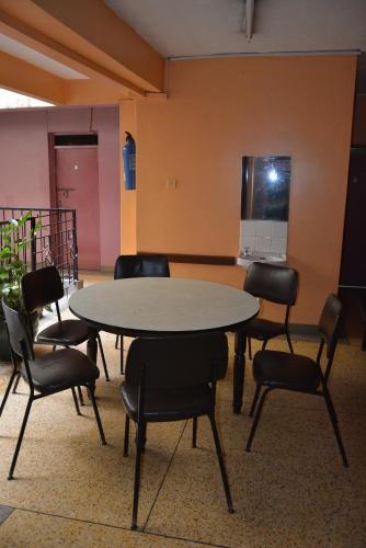 a meeting room with a table and chairs at New Swanga in Nairobi