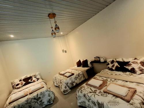 a bedroom with two beds and a couch in it at Yaga's Stay INN save in Impasugong