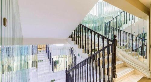 a staircase in a house with a mural on the wall at Xana Hotelle· Tianjin Railway Station Jinwan Square Binjiang Avenue in Tianjin
