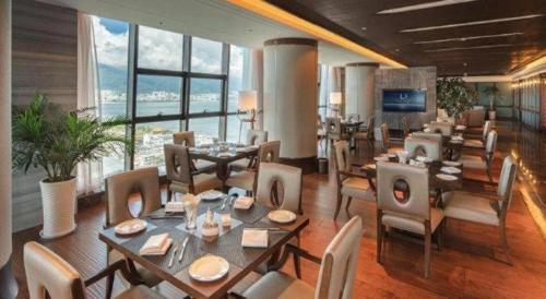 a restaurant with tables and chairs and a large window at Dali Hotel in Dali
