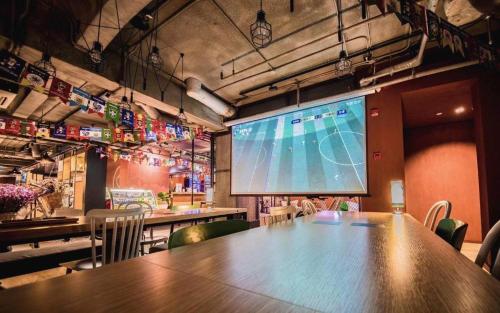 a large projection screen in a room with a table at YUNIK-Shanghai Zhongshan Park Yan'an Xi Road in Shanghai