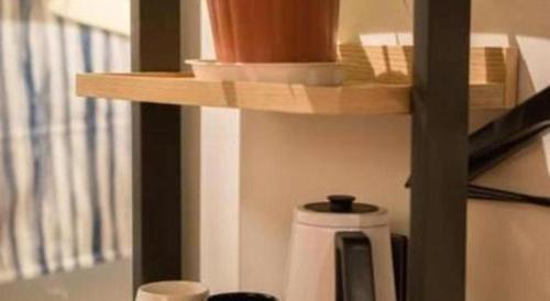 a wooden shelf above a coffee pot on a counter at YUNIK-Shanghai Zhongshan Park Yan'an Xi Road in Shanghai
