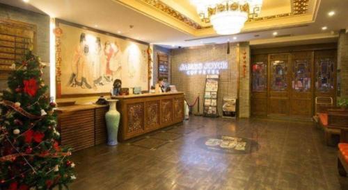 a lobby with a christmas tree in a store at James Joyce Coffetel Xian Dayanta Metro Station Branch in Xi'an