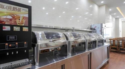 a row of stainless steel food machines on a counter at GreenTree Inn Jiaxin Puyuan Kaixuan Road in Jiaxing